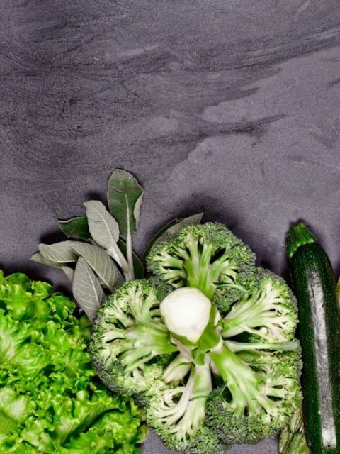 Broccoli, celery, and celery stalks laid out on