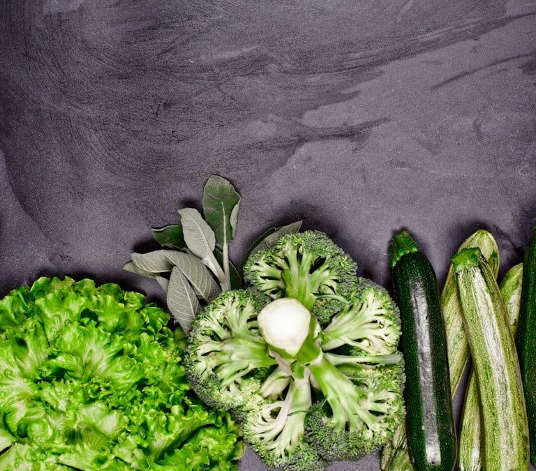 Broccoli, celery, and celery stalks laid out on